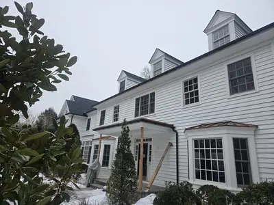 6-inch gutters on luxury estate - Need: 400x300px image of 6-inch gutters on upscale luxury home with complex roofline