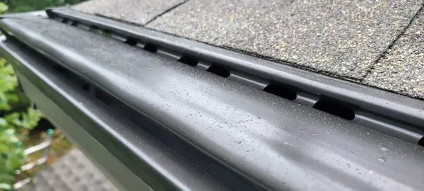 Guttershell double-drop aluminum gutter guards installed - Need: 600x400px image of Guttershell guards showing the double-drop design