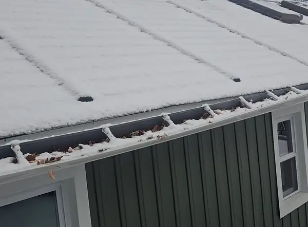 Gutter repair in progress - Need: 600x500px image of technician repairing gutters
